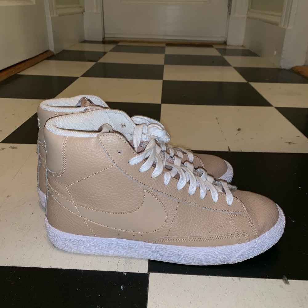 Tan and white high top Nike’s